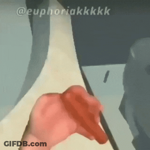 A Close Up Of A Person 'S Hand Holding A Red Object With The Words Euphoriakkkk Below It . GIF