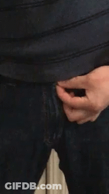 A Close Up Of A Person 'S Hand Holding A Zipper On A Pair Of Jeans GIF