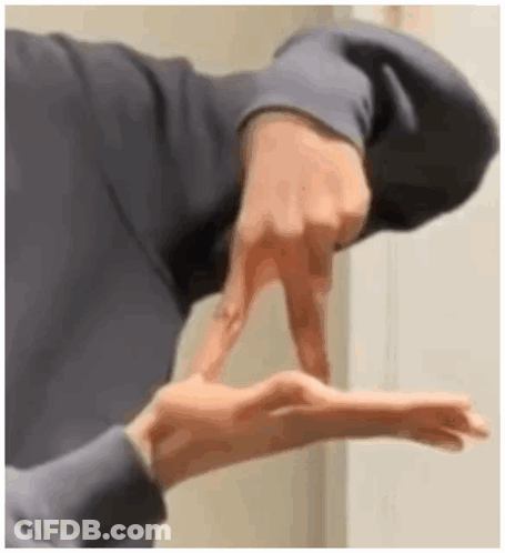 A Close Up Of A Person 'S Hand Making A Sign With Their Fingers . GIF