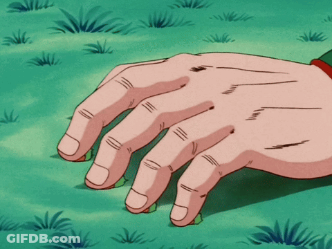 A Close Up Of A Person 'S Hand On A Green Field GIF