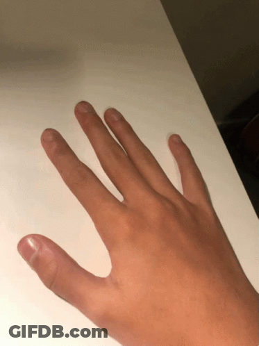 A Close Up Of A Person 'S Hand On A White Table GIF