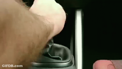 A Close Up Of A Person 'S Hand Pressing A Button On A Remote Control . GIF