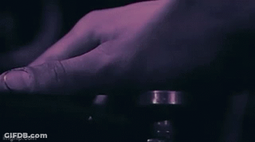 A Close Up Of A Person 'S Hand Pressing A Button With A Purple Background . GIF