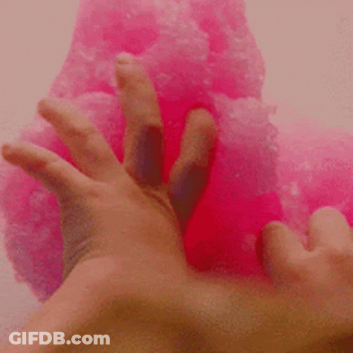 A Close Up Of A Person 'S Hand Touching A Pink Slime . GIF