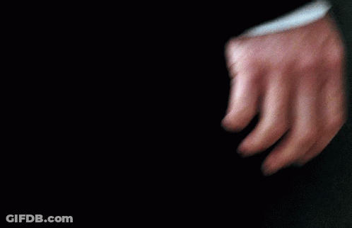 A Close Up Of A Person 'S Hand With A Black Shirt On GIF