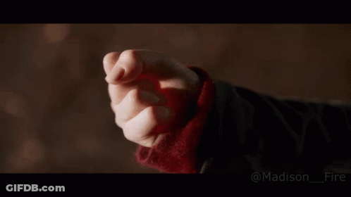 A Close Up Of A Person 'S Hand With A Fire Coming Out Of It . GIF