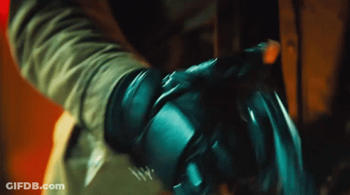 A Close Up Of A Person 'S Hand With A Glove On GIF