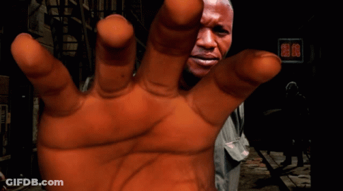 A Close Up Of A Person 'S Hand With A Man 'S Face In The Background GIF