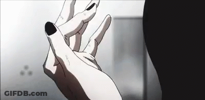 A Close Up Of A Person 'S Hand With Black Nails And A Black Nail Polish . GIF