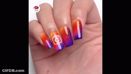 A Close Up Of A Person 'S Hand With Colorful Nails And A Instagram Logo On Them GIF