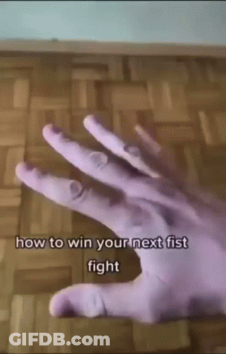 A Close Up Of A Person 'S Hand With The Words `` How To Win Your Next Fist Fight '' Written On It GIF