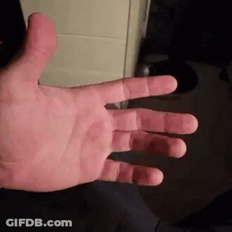 A Close Up Of A Person 'S Hand With Their Fingers Outstretched And A Black Background . GIF