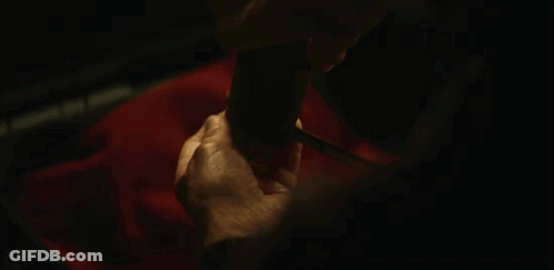 A Close Up Of A Person 'S Hands Holding A Pair Of Knitting Needles GIF