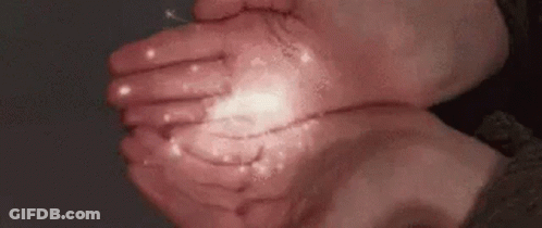 A Close Up Of A Person 'S Hands Holding Something In Their Hands . GIF