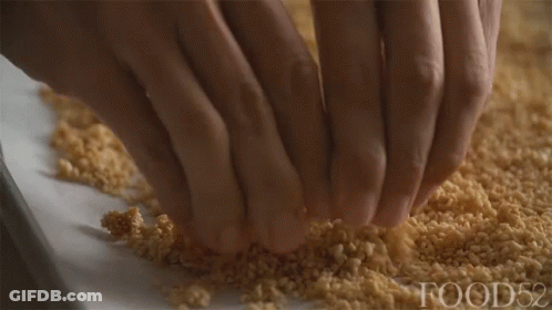 A Close Up Of A Person 'S Hands On A Pile Of Food52 GIF