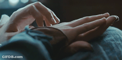 A Close Up Of A Person 'S Hands Touching Another Person 'S Hand GIF