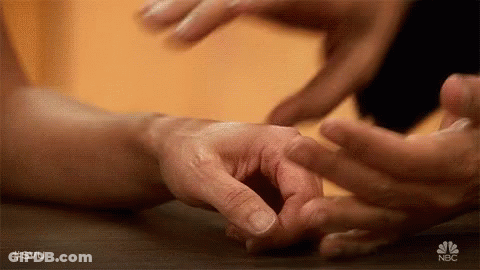 A Close Up Of A Person 'S Hands Touching Each Other . GIF