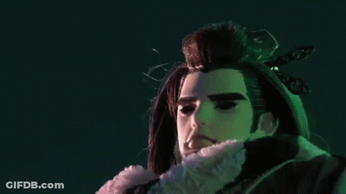 A Close Up Of A Person 'S Hands With A Purple Object Between Them GIF