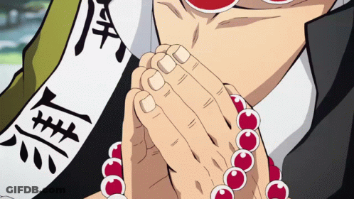 A Close Up Of A Person 'S Hands With Red Beads And Chinese Writing On A Banner GIF