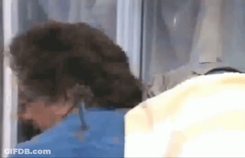 A Close Up Of A Person 'S Head Behind A Glass Door GIF