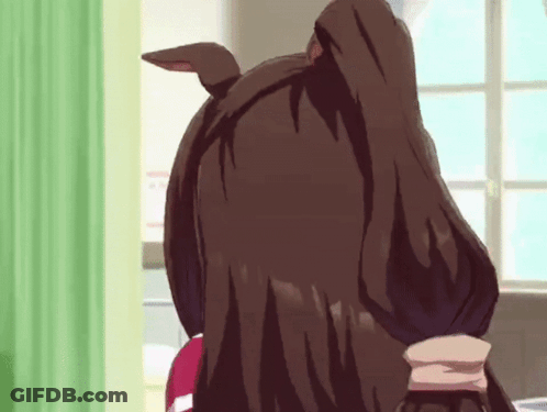 A Close Up Of A Person 'S Head With A Green Curtain In The Background GIF