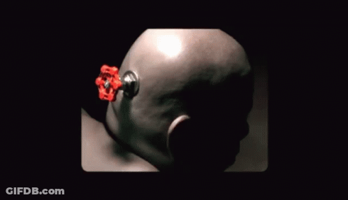 A Close Up Of A Person 'S Head With A Red Object Sticking Out GIF