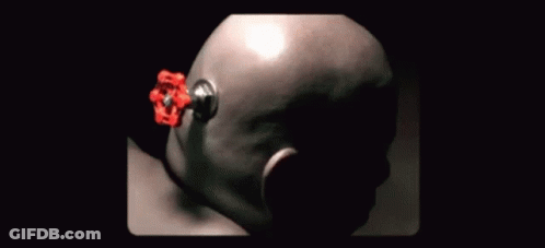 A Close Up Of A Person 'S Head With A Red Object Sticking Out Of It GIF