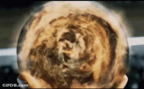 A Close Up Of A Person 'S Head With A Sphere Of Fire Coming Out Of It GIF