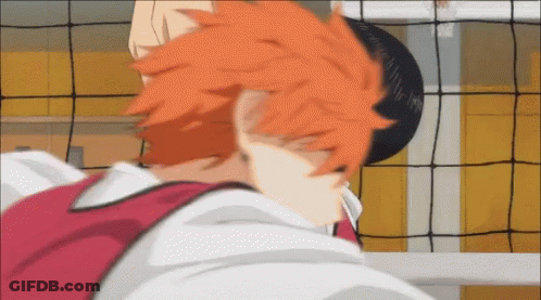 A Close Up Of A Person 'S Head With Orange Hair In Front Of A Volleyball Net GIF