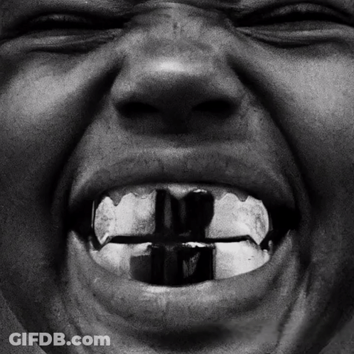 A Close Up Of A Person 'S Mouth With A Cross In The Middle Of It GIF