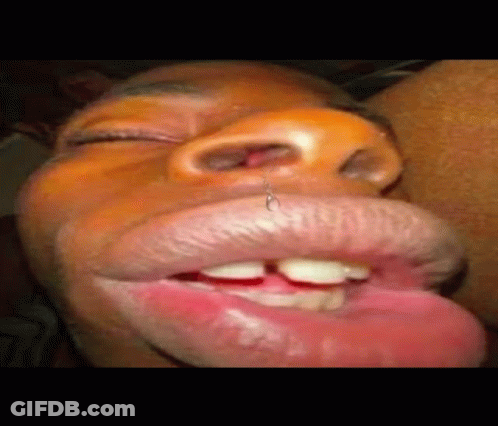 A Close Up Of A Person 'S Mouth With A Piercing In It And Their Tongue Sticking Out . GIF