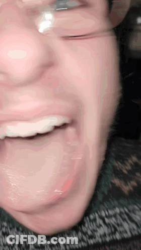 A Close Up Of A Person 'S Mouth With Glasses GIF