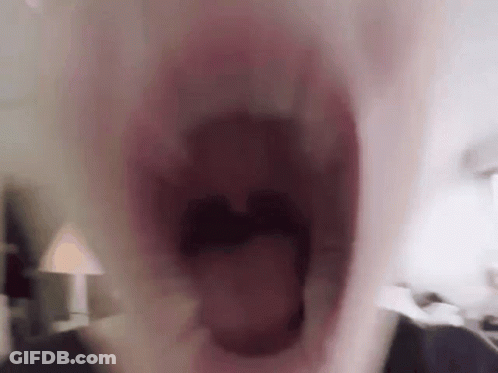 A Close Up Of A Person 'S Mouth With Their Mouth Wide Open GIF