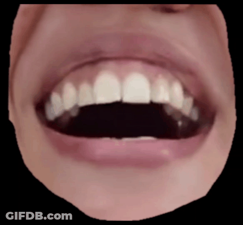 A Close Up Of A Person 'S Mouth With Their Teeth Showing GIF