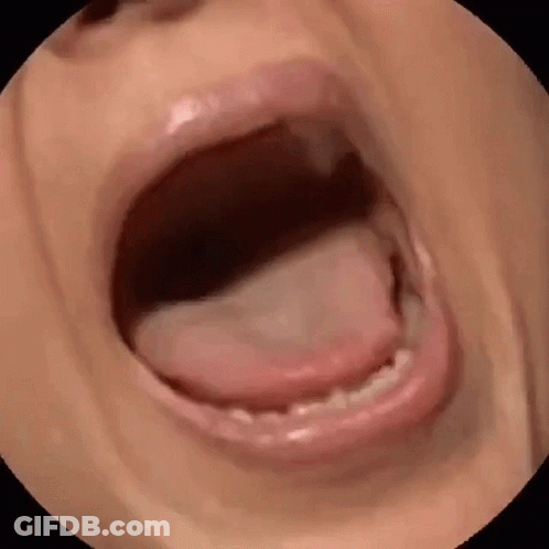A Close Up Of A Person 'S Mouth With Their Tongue Sticking Out GIF