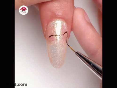 A Close Up Of A Person 'S Nails With The Word Nails On The Bottom Right GIF