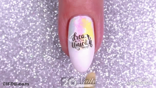 A Close Up Of A Person 'S Nails With The Words `` Dream Like A Unicorn '' Painted On Them . GIF