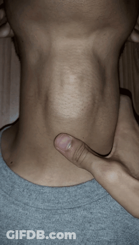 A Close Up Of A Person 'S Neck With Their Thumb On It GIF