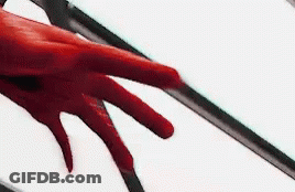 A Close Up Of A Person 'S Red Hand Reaching Out Towards A White Background . GIF