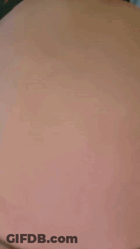 A Close Up Of A Person 'S Stomach With A Black Shirt On . GIF