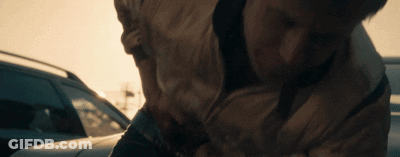A Close Up Of A Person 'S Torso While Standing Next To A Car GIF