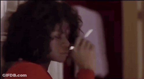 A Close Up Of A Person Smoking A Cigarette In A Bathroom . GIF