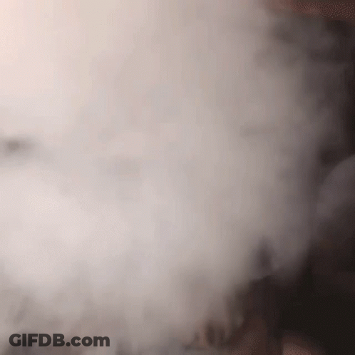 A Close Up Of A Person Smoking A Hookah With Smoke Coming Out Of It GIF