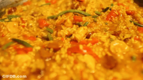 A Close Up Of A Person Stirring A Pot Of Food With A Fork . GIF