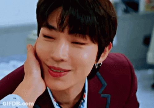 A Close Up Of A Person Touching A Man 'S Face With Their Hand . GIF
