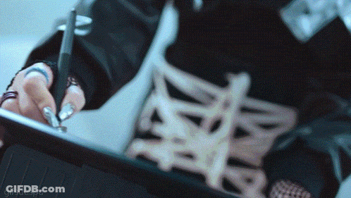 A Close Up Of A Person Using A Pen On A Tablet With A Gifscaespa Watermark GIF