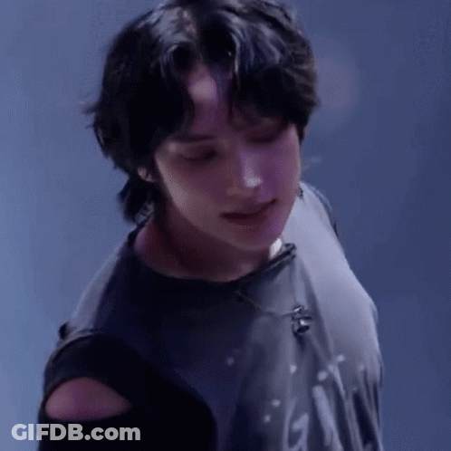 A Close Up Of A Person Wearing A Black Shirt With A Microphone On It . GIF