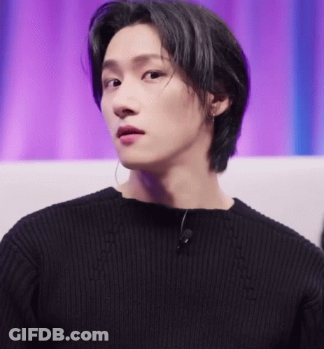 A Close Up Of A Person Wearing A Black Sweater And A Microphone GIF