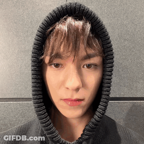 A Close Up Of A Person Wearing A Black Sweater With A Hood GIF