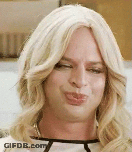 A Close Up Of A Person Wearing A Blonde Wig Making A Face . GIF